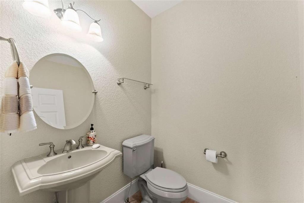 777 Oak Pointe Drive Cleveland, GA 30528 - Photo 24 of 63 a bathroom with a toilet a sink a mirror and vanity
