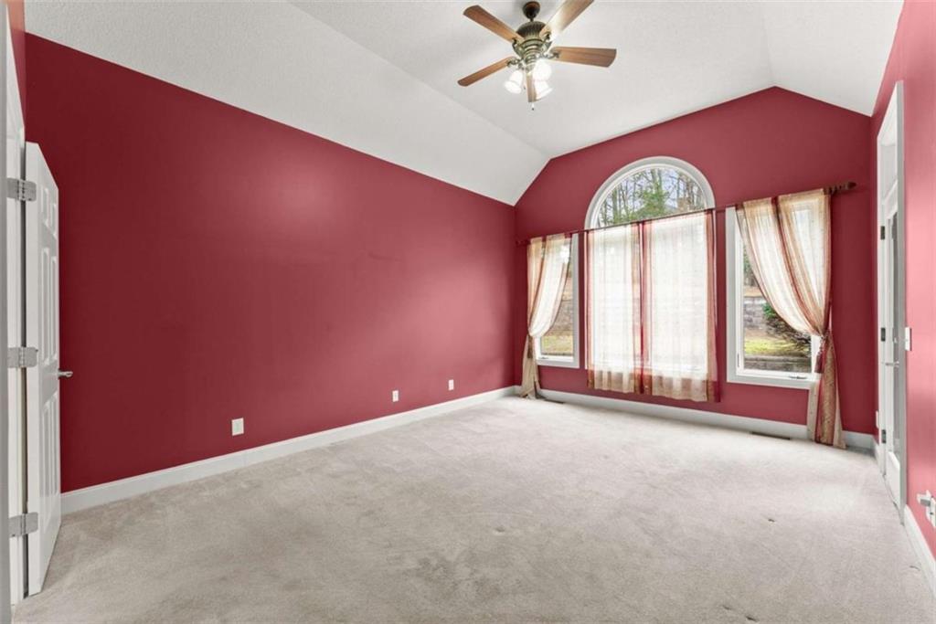 777 Oak Pointe Drive Cleveland, GA 30528 - Photo 27 of 63 an empty room with windows and chandelier fan