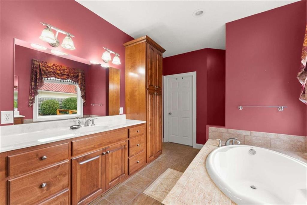 777 Oak Pointe Drive Cleveland, GA 30528 - Photo 31 of 63 a spacious bathroom with a tub sink and mirror