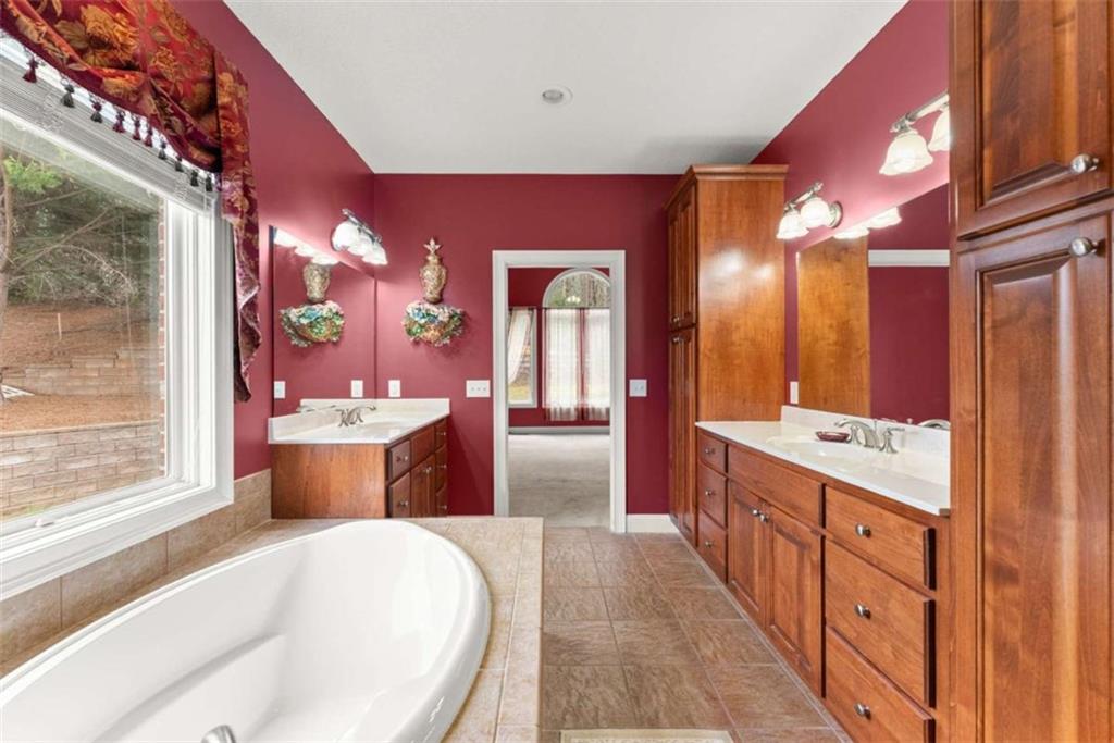 777 Oak Pointe Drive Cleveland, GA 30528 - Photo 33 of 63 a large bathroom with a large tub sink shower and mirror