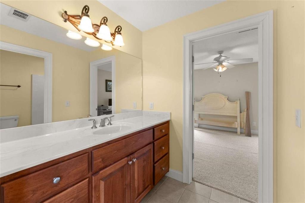 777 Oak Pointe Drive Cleveland, GA 30528 - Photo 38 of 63 a en suite bathroom with a double vanity sink and a mirror