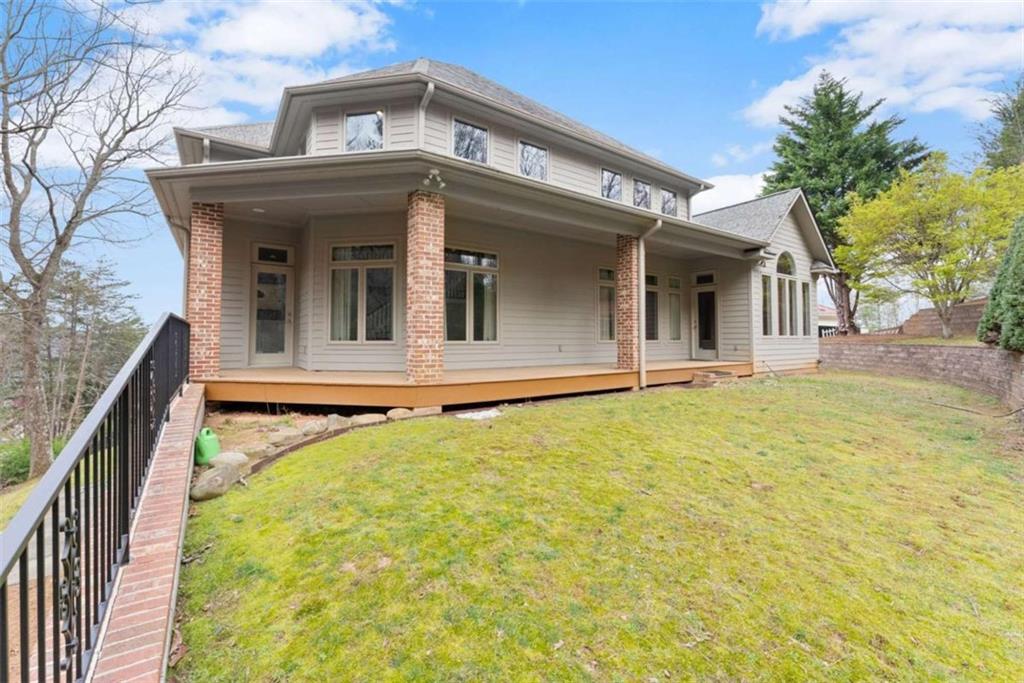 777 Oak Pointe Drive Cleveland, GA 30528 - Photo 48 of 63 a view of a white house with large windows