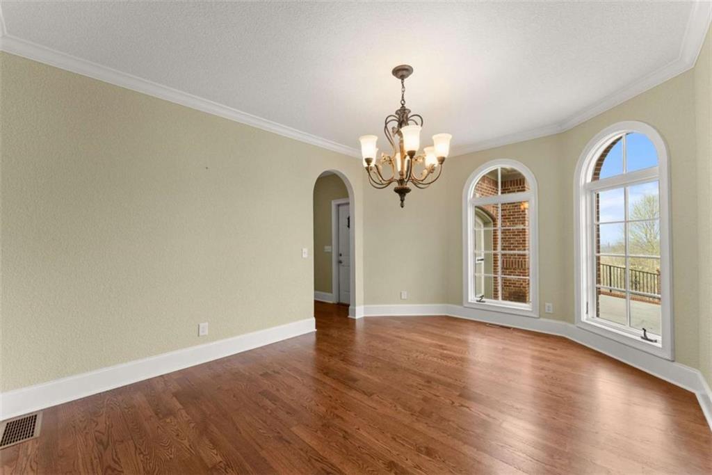 777 Oak Pointe Drive Cleveland, GA 30528 - Photo 9 of 63 a view of a big room with wooden floor chandelier and windows