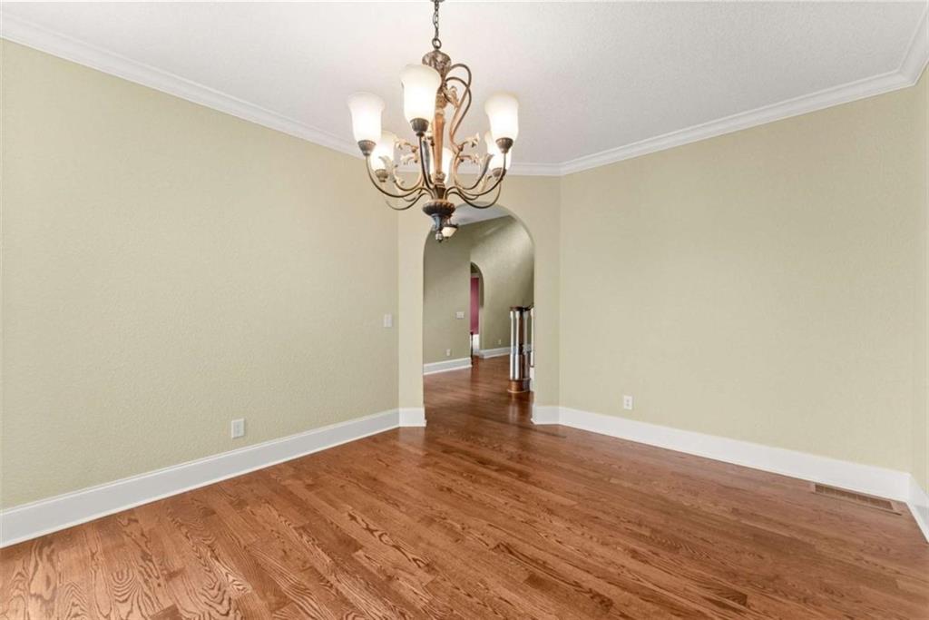 777 Oak Pointe Drive Cleveland, GA 30528 - Photo 10 of 63 a view of a room with wooden floor and chandelier