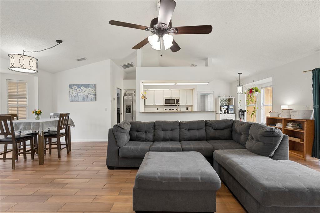 9917 Nelson Road Dade City, FL 33525 - Photo 11 of 40 a living room with furniture and a dining table
