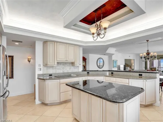 a kitchen with a sink a counter top space cabinets and stainless steel appliances