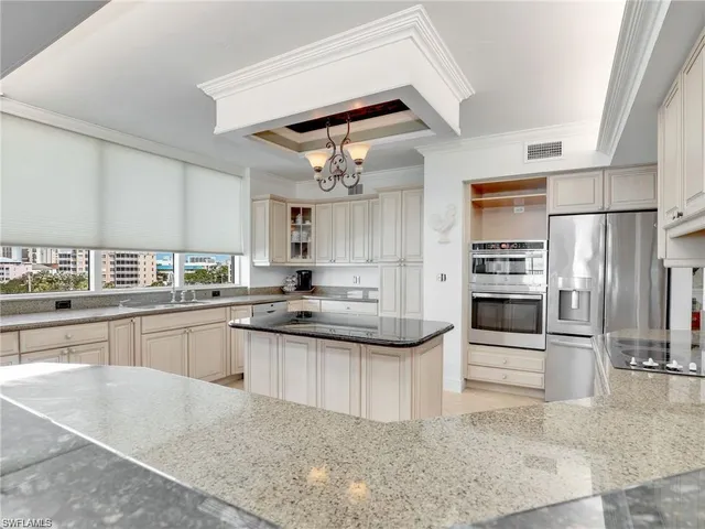 a kitchen with stainless steel appliances granite countertop a sink and cabinets