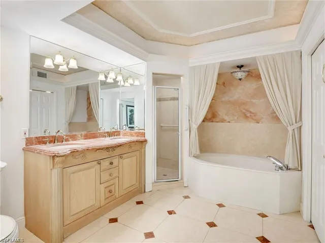 a bathroom with a granite countertop sink a toilet and shower