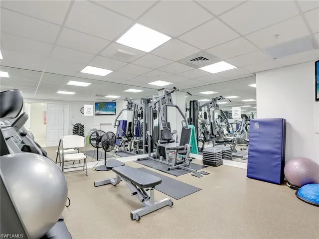 a living room with lots of furniture and gym equipment
