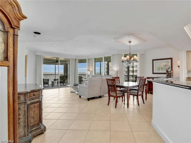 a dining room with furniture and chandelier