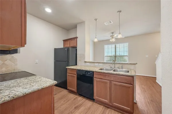 a kitchen with a sink and a refrigerator