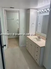 a bathroom with a granite countertop sink a mirror and a