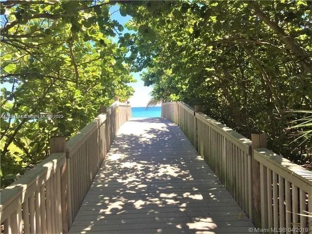 a view of a pathway both side of house