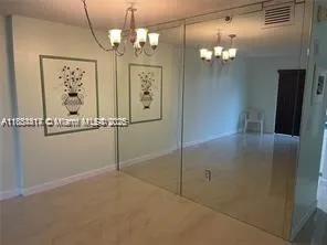 a view of a hallway with chandelier