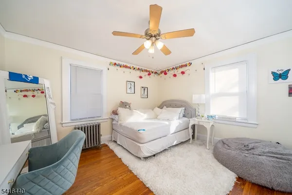 a spacious bedroom with a bed couch and window