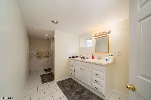 a bathroom with a double vanity sink mirror and toilet