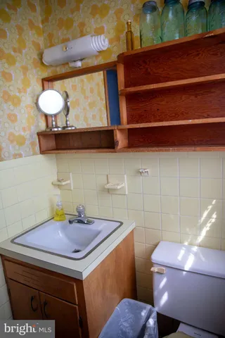 a view of a hallway with wooden floor windows and a livingroom