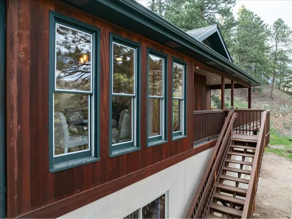 a view of a balcony with chairs and wooden floor