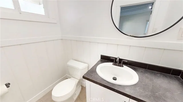 a bathroom with a sink mirror and toilet
