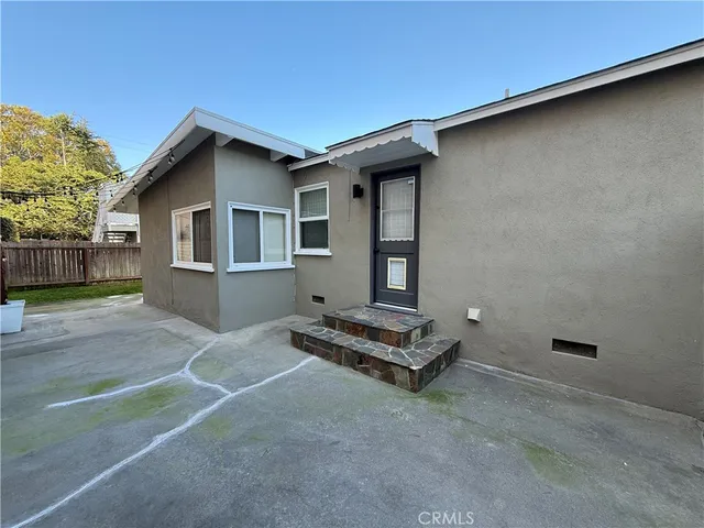 a view of a house with backyard and a tree