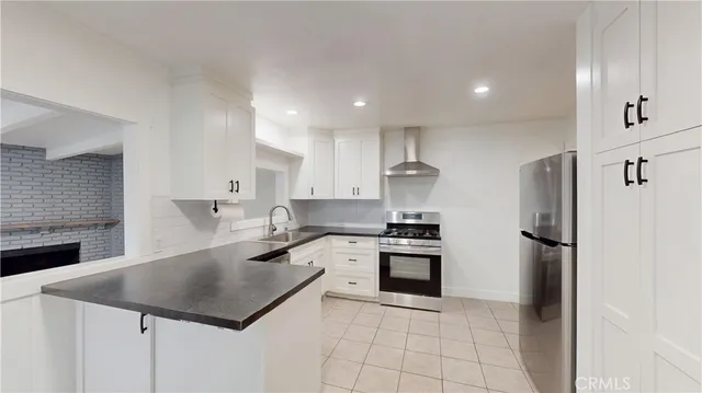 a kitchen with a stove a refrigerator and a sink