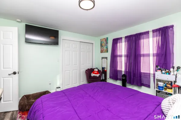 a bedroom with a bed and window
