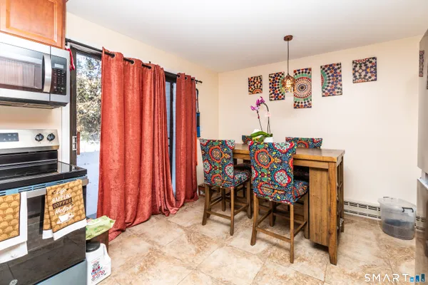 a view of a dining room with furniture and a kitchen