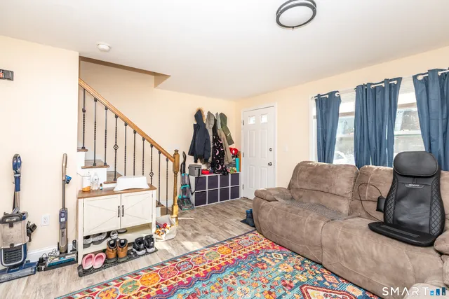 a living room with furniture and a floor to ceiling window