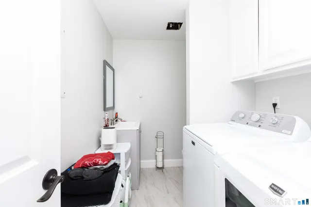 a utility room with sink dryer and washer