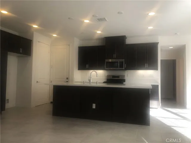 a kitchen with stainless steel appliances a sink and a stove