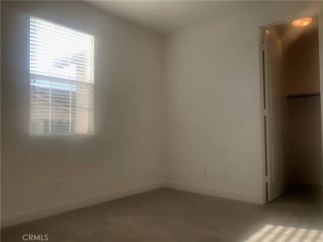 an empty room with a empty space and windows