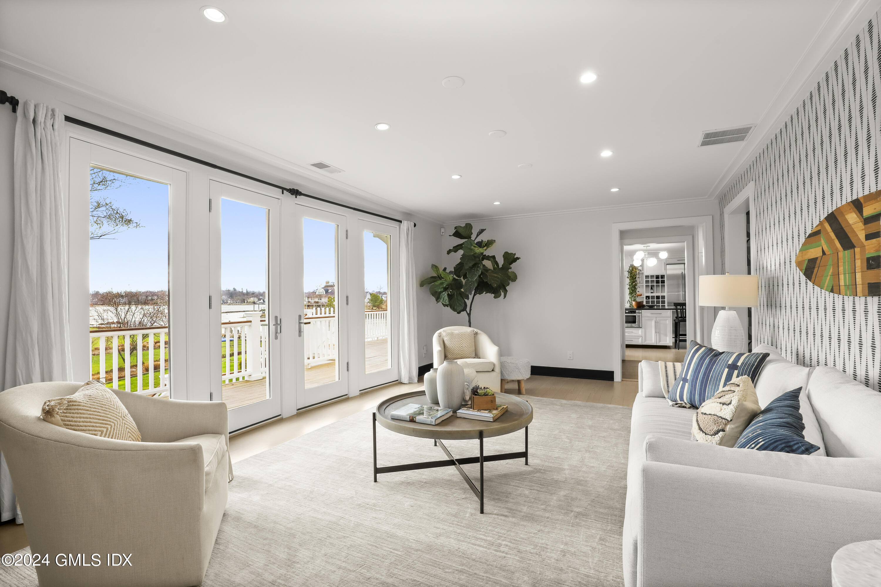 195 Shore Road Old Greenwich, CT 06870 - Photo 11 of 39 a living room with furniture and a large window
