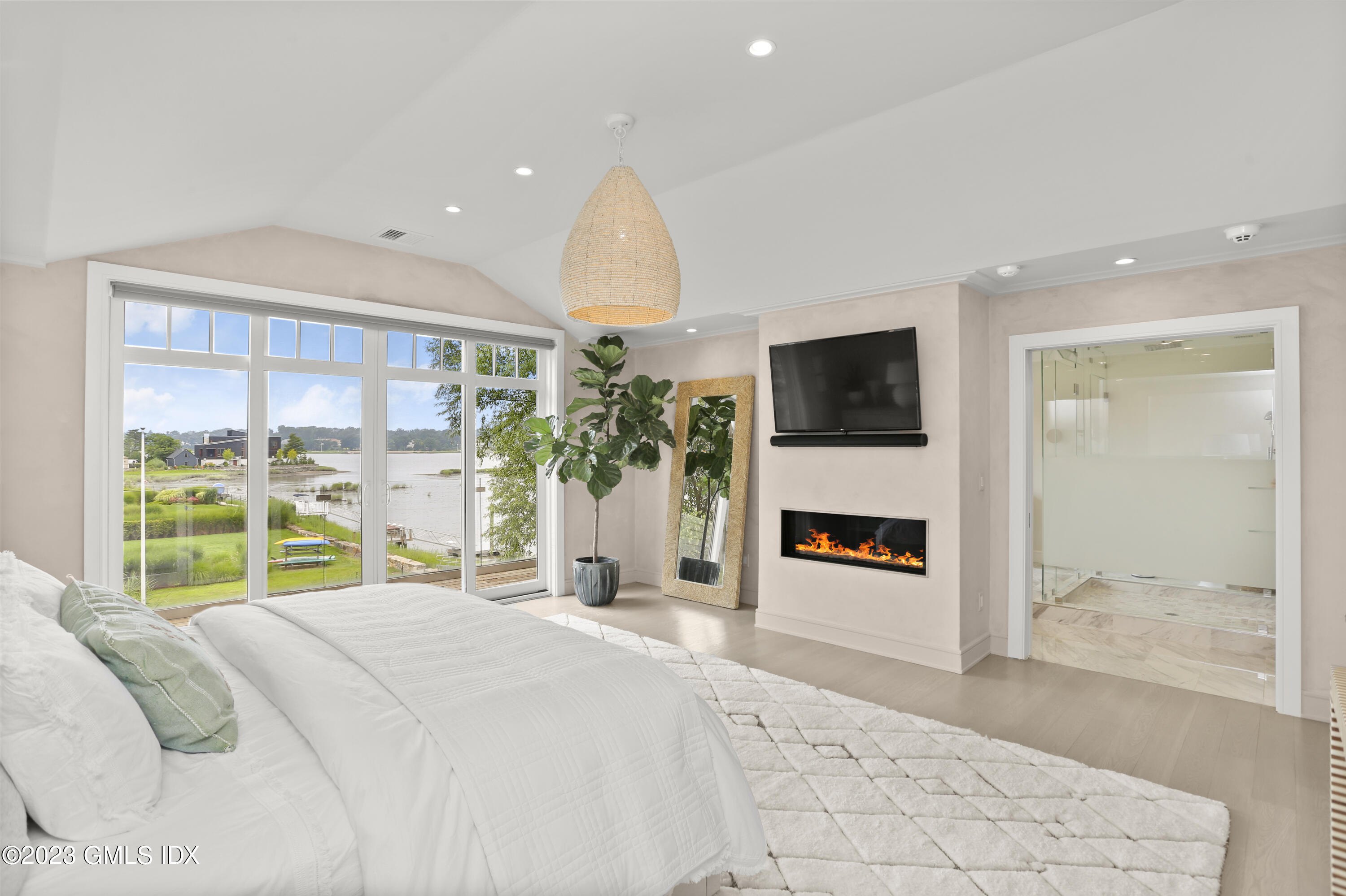 195 Shore Road Old Greenwich, CT 06870 - Photo 13 of 39 a bedroom with a bed and a large window