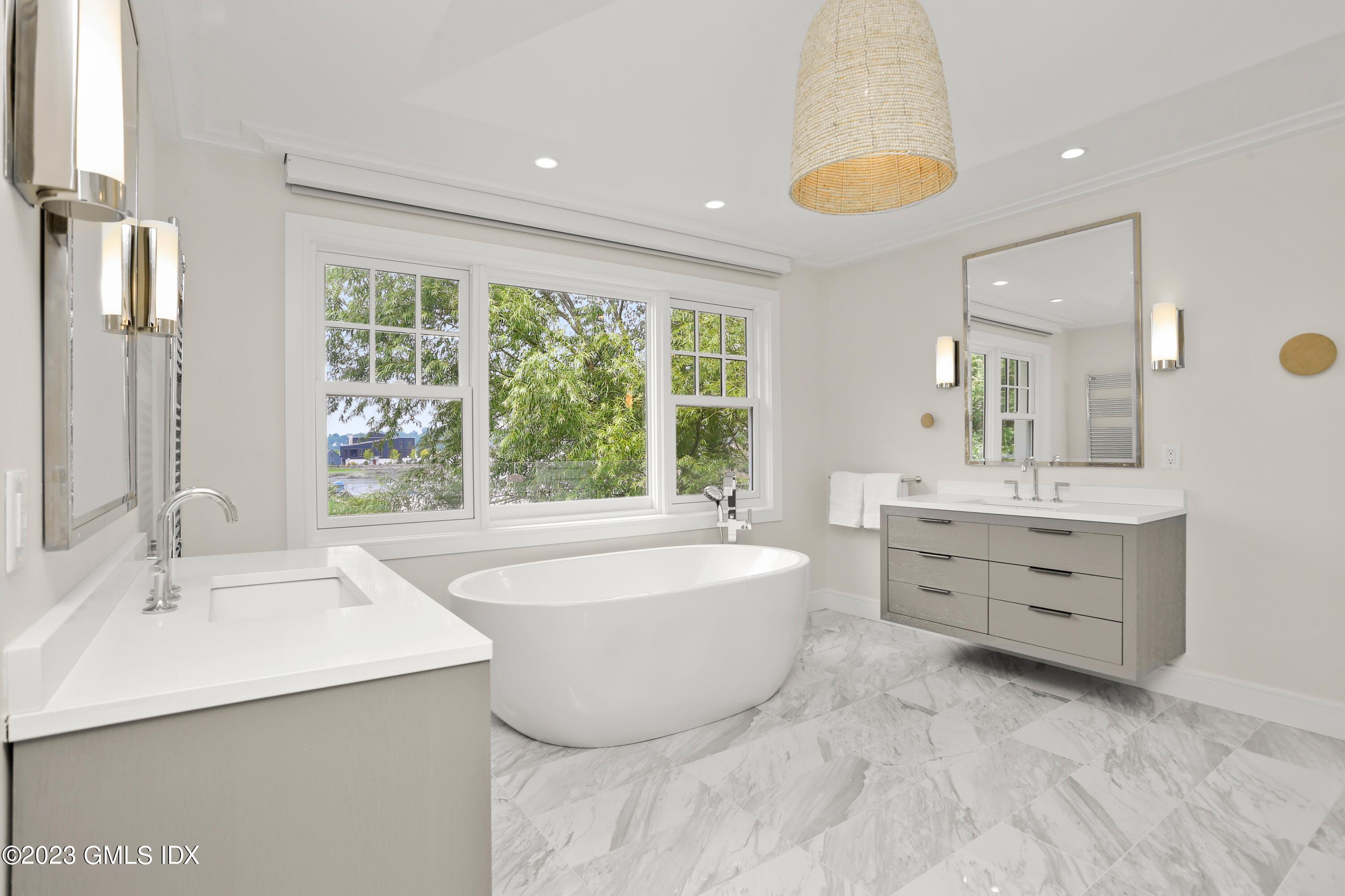 195 Shore Road Old Greenwich, CT 06870 - Photo 14 of 39 a spacious bathroom with a double vanity sink large mirror and a bathtub