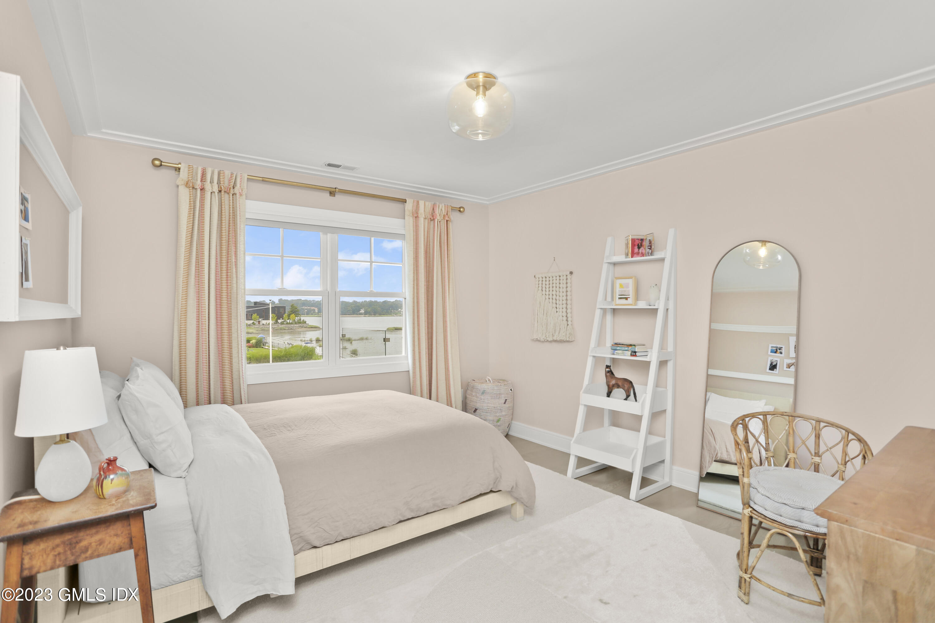 195 Shore Road Old Greenwich, CT 06870 - Photo 15 of 39 a bedroom with a bed and a chair