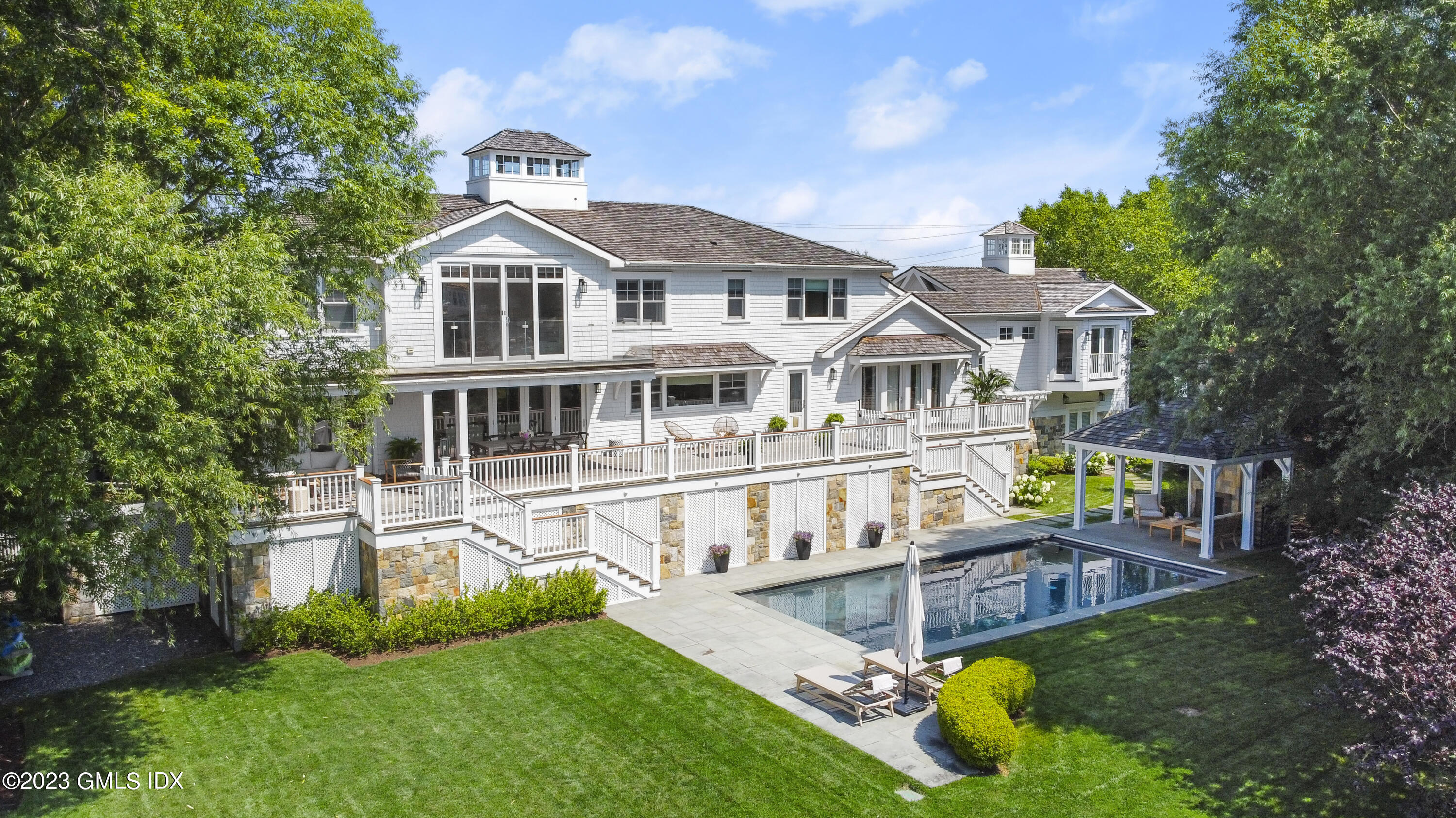 195 Shore Road Old Greenwich, CT 06870 - Photo 2 of 39 a front view of a house with garden