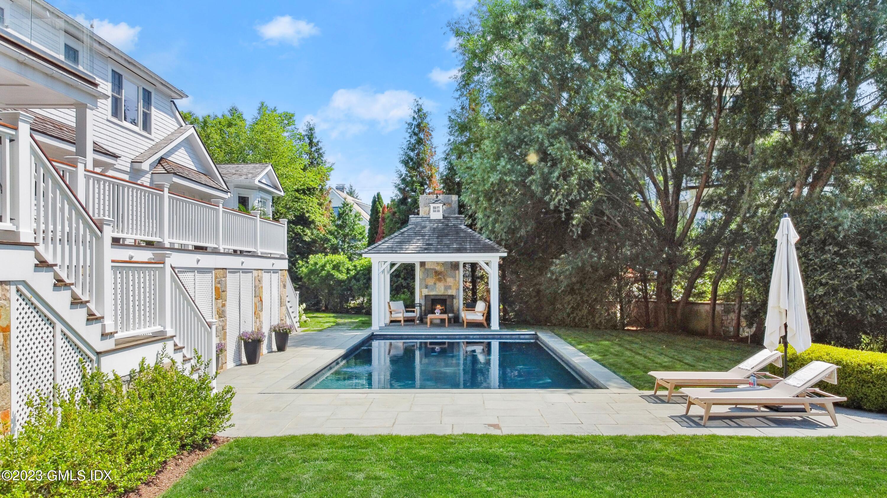 195 Shore Road Old Greenwich, CT 06870 - Photo 23 of 39 a view of a house with a yard patio and fire pit