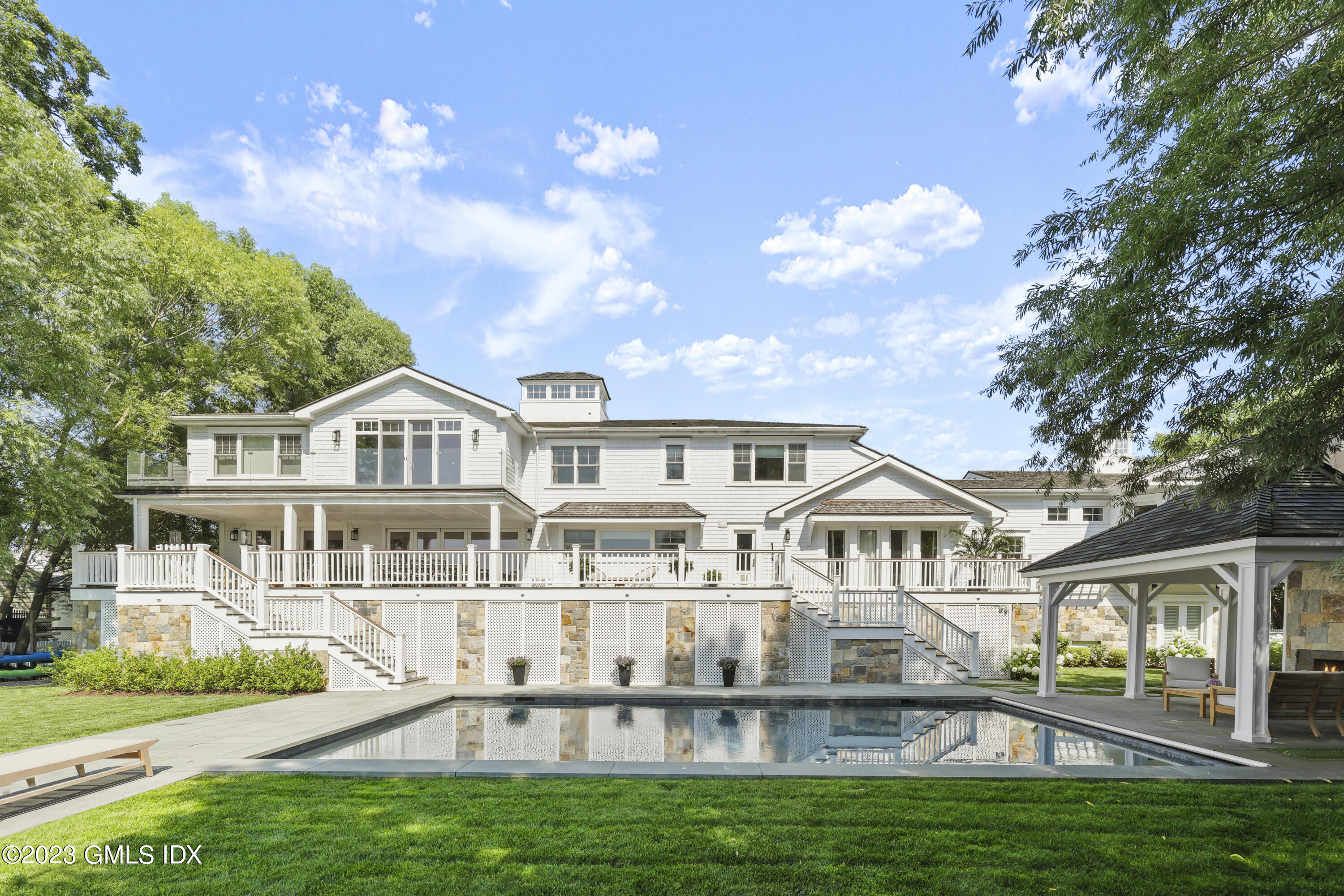 195 Shore Road Old Greenwich, CT 06870 - Photo 24 of 39 a front view of a house with a yard
