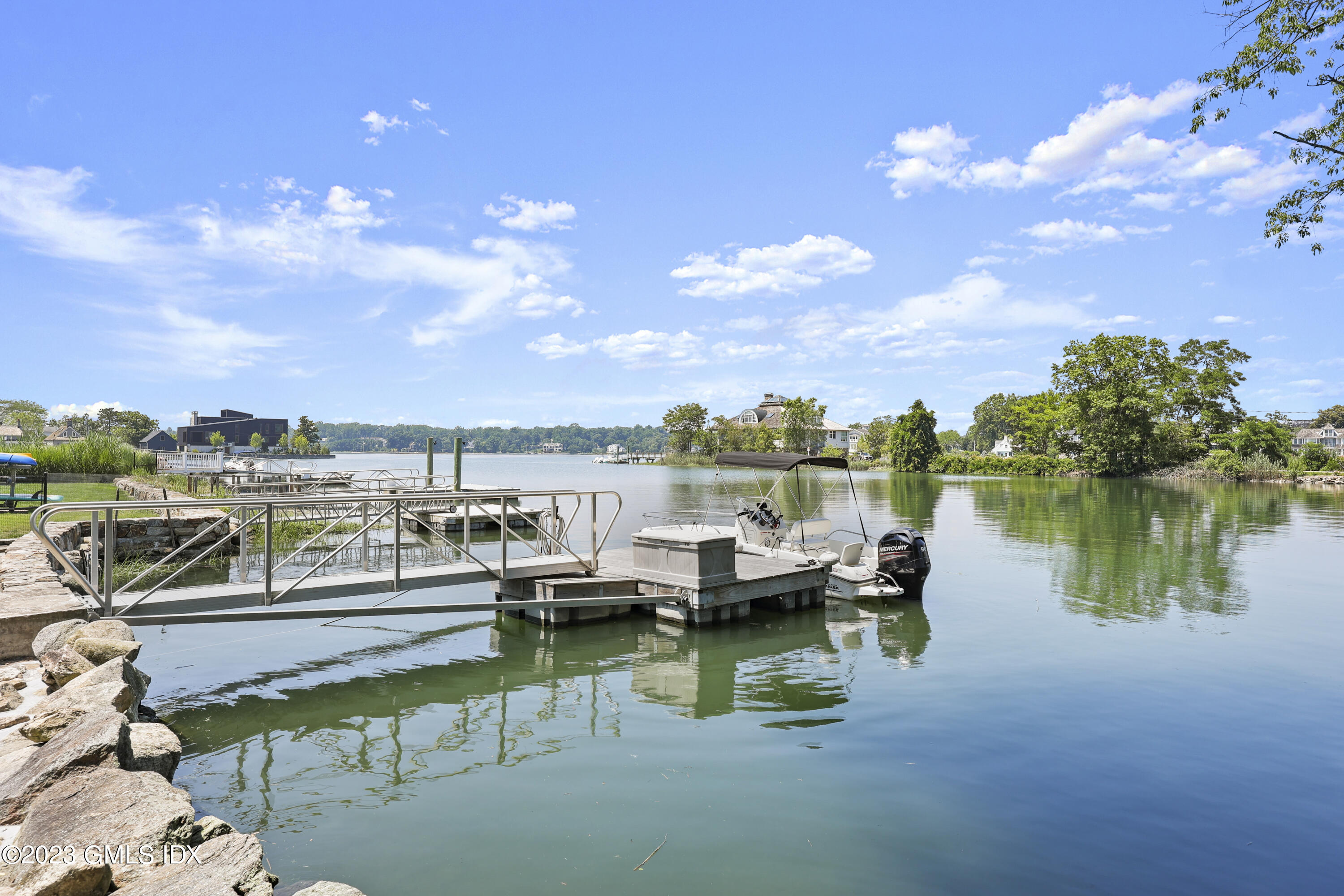 195 Shore Road Old Greenwich, CT 06870 - Photo 29 of 39 a view of a lake with lawn chairs