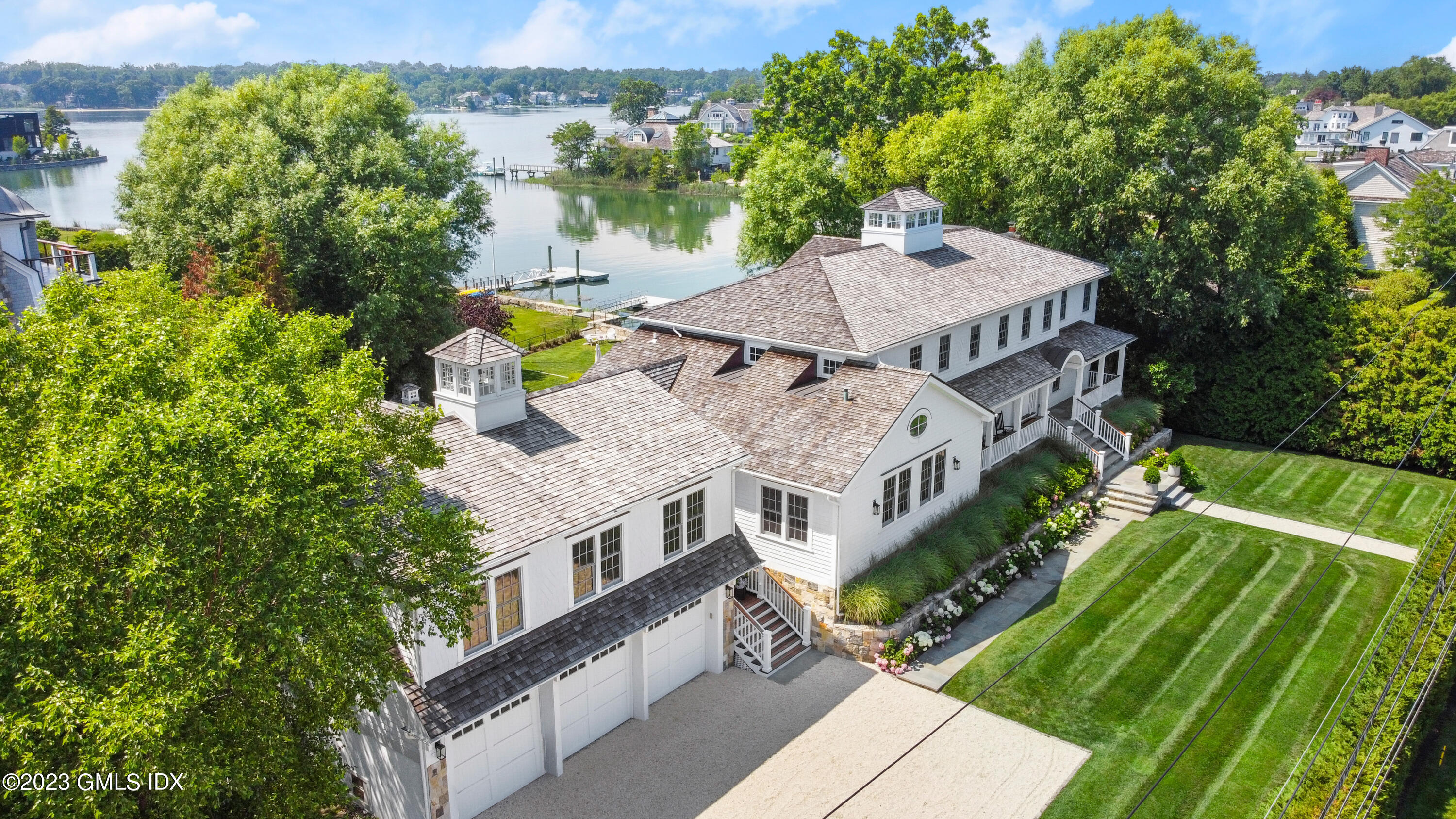 195 Shore Road Old Greenwich, CT 06870 - Photo 3 of 39 an aerial view of a house with a big yard and large trees