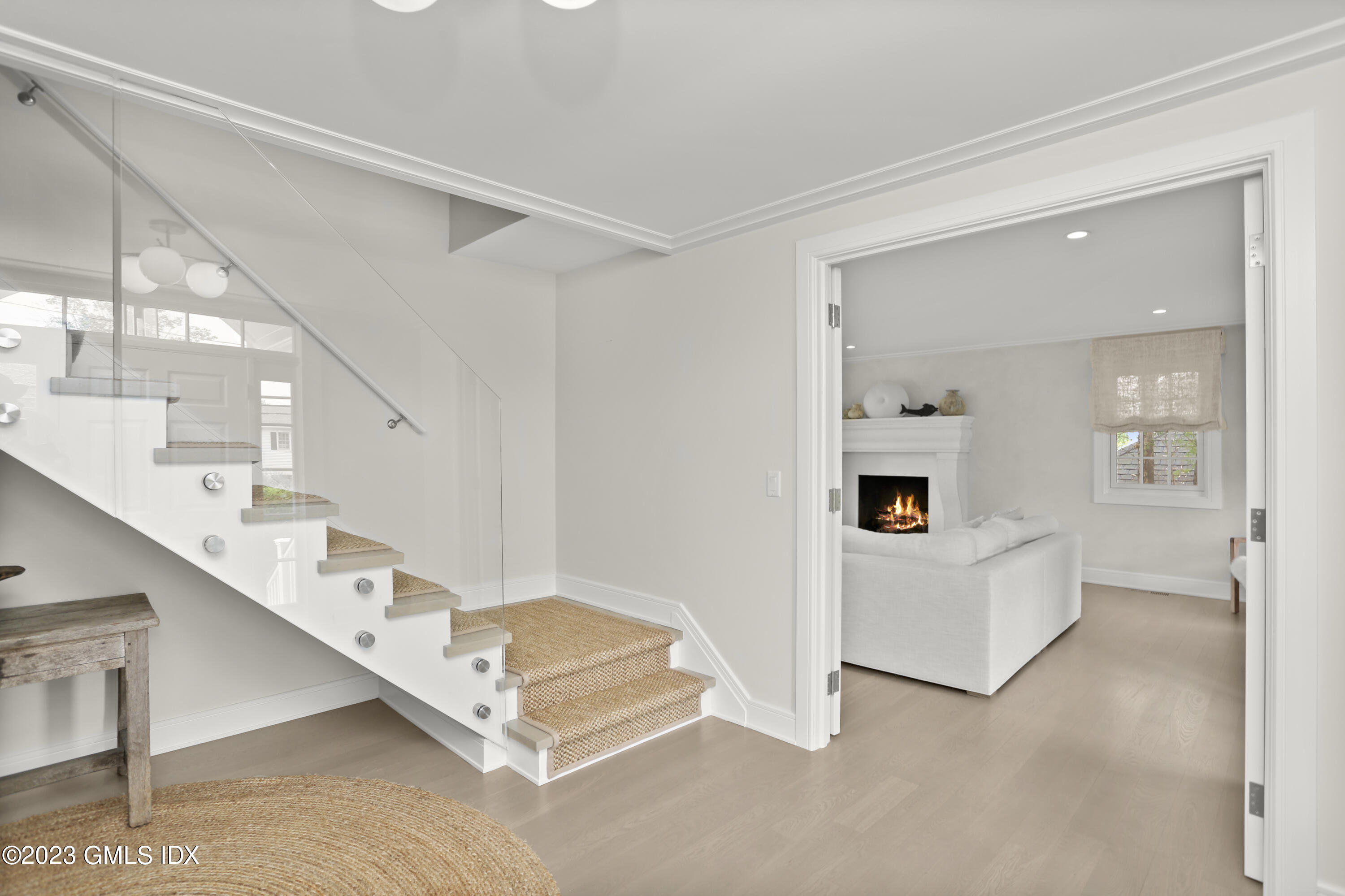 195 Shore Road Old Greenwich, CT 06870 - Photo 5 of 39 a living room with windows and stairs