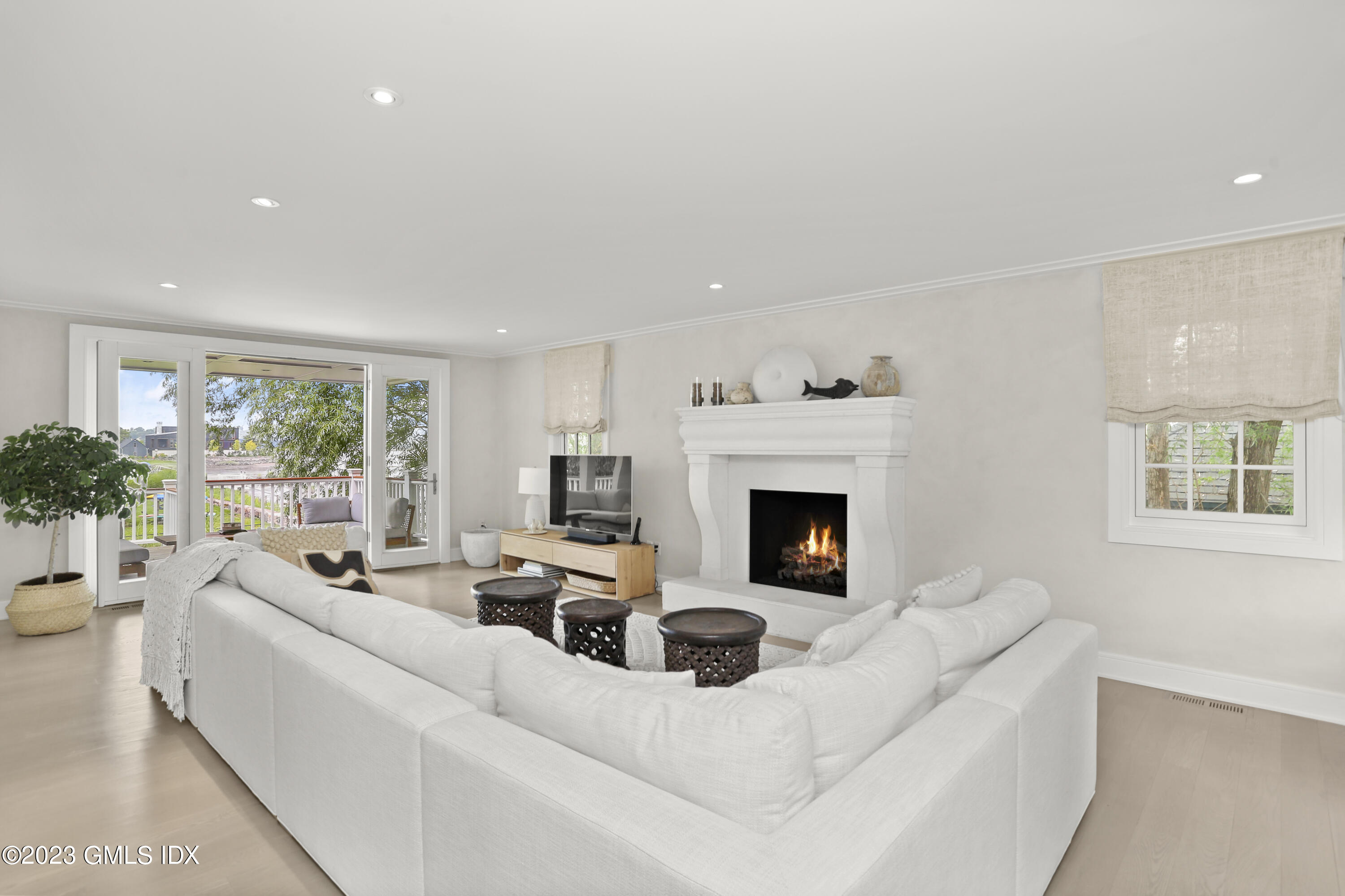 195 Shore Road Old Greenwich, CT 06870 - Photo 6 of 39 a living room with furniture and a fireplace