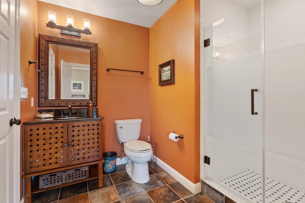 34 Woodcliffe Road Lexington, MA 02421 - Photo 19 of 34 a bathroom with a toilet a sink and mirror
