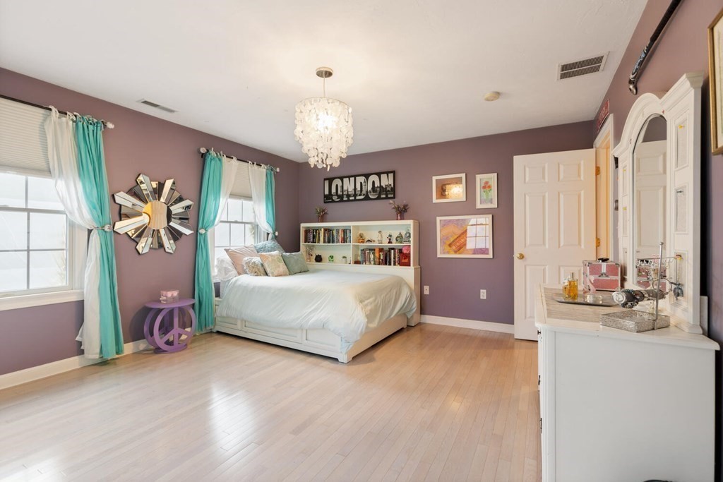 34 Woodcliffe Road Lexington, MA 02421 - Photo 30 of 34 a bedroom with a large bed and a chandelier