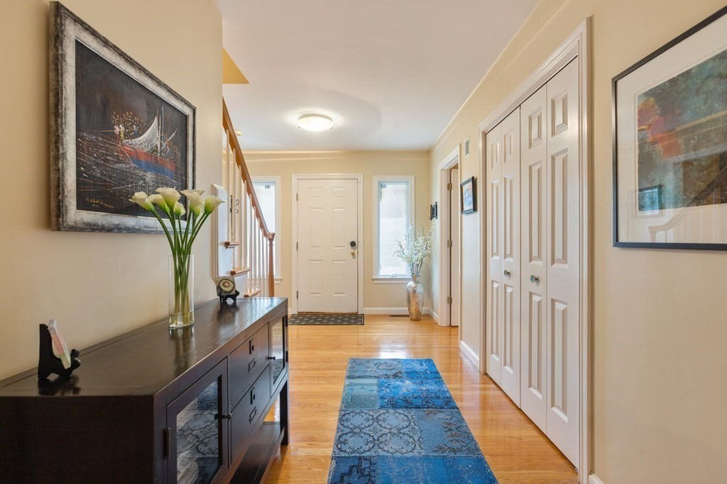 34 Woodcliffe Road Lexington, MA 02421 - Photo 6 of 34 a hallway with wooden floor and a painting on the wall