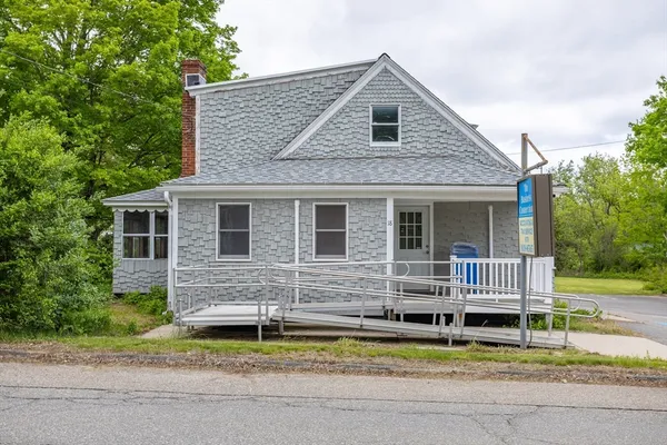 a front view of a house with a yard and porch