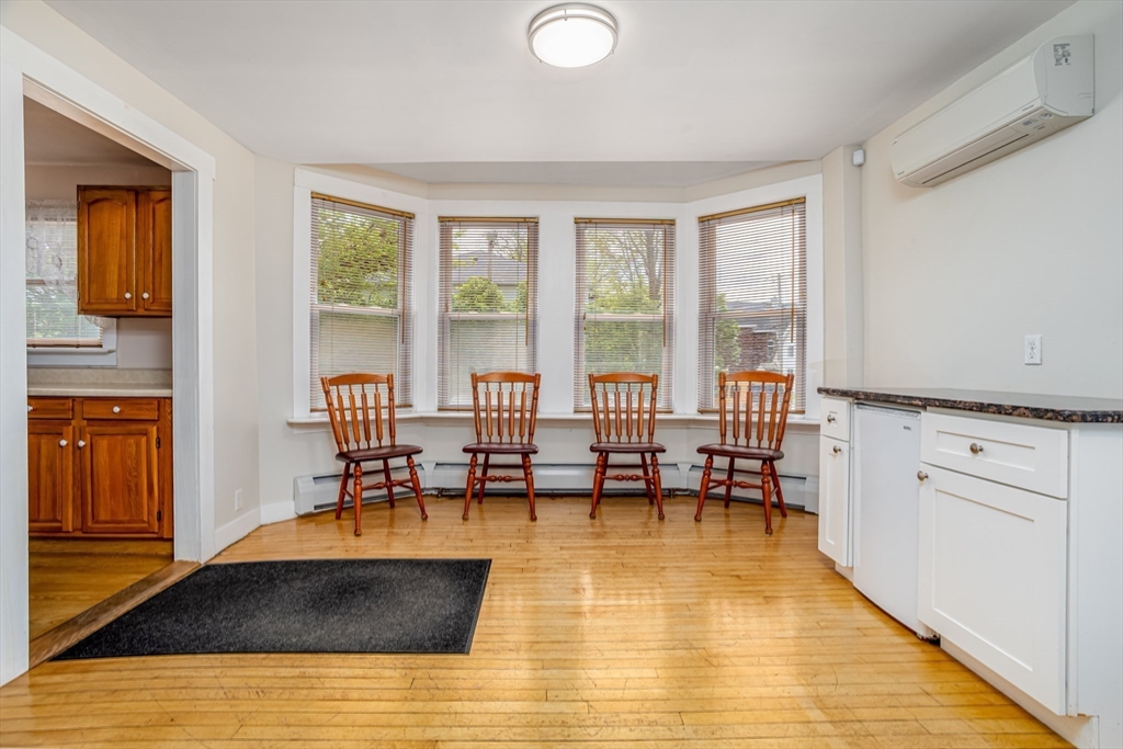 18 North Main Street Templeton, MA 01436 - Photo 11 of 42 a living room with stainless steel appliances granite countertop a couch and a dining table with wooden floor