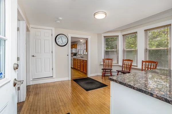 a view of a livingroom with furniture wooden floor and front door