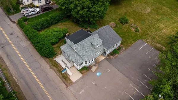 an aerial view of a house with garden space and street view