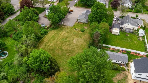 an aerial view of residential house with an outdoor space and seating